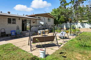 Back of property featuring a patio and brick siding
