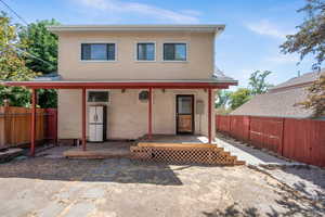Fully fenced backyard with covered deck.