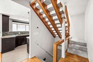 Staircase featuring wood finished floors