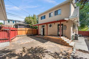 Fully fenced backyard with covered deck.