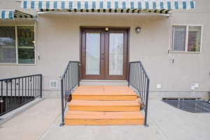 Entrance to the main level and to the left the exterior entrance to the basement