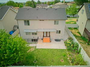 Backyard with garden space, beuatiful flowers, and some fruit trees.