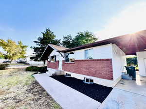 View of side of home with brick siding