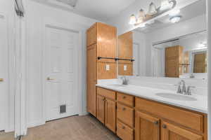Bathroom featuring double vanity and light tile patterned floors