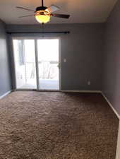 Spare room with carpet floors, healthy amount of natural light, and a ceiling fan