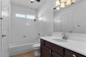 Bathroom with vanity, tub / shower combination, ceiling fan, and light tile patterned flooring