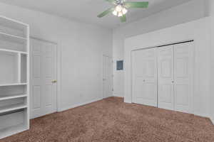 Unfurnished bedroom with carpet floors, a closet, a ceiling fan, and electric panel