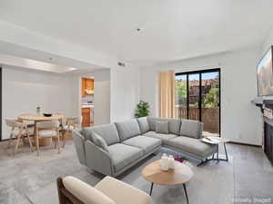 Living area with light carpet and a fireplace