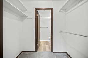 Walk in closet featuring light carpet