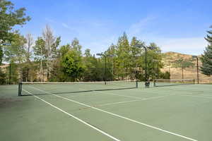 View of tennis court with community basketball court