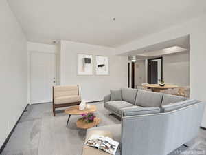 Living area featuring carpet and baseboards