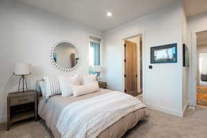 Bedroom featuring light carpet and recessed lighting
