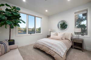Bedroom featuring carpet, multiple windows, and recessed lighting