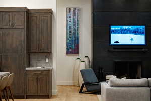 Office space featuring a large fireplace and light wood-style floors