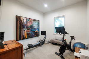 Workout area with carpet floors and baseboards
