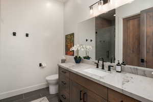 Full bathroom with vanity, a shower stall, and wood tiled floors