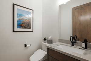 Half bath with vanity and toilet