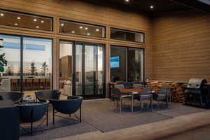 View of patio with outdoor dining area and grilling area
