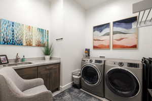 Washroom featuring washer and dryer and a sink