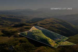 Aerial overview of property's location with a mountainous background and property parcel outlined