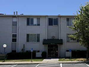 View of building exterior with uncovered parking