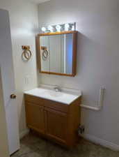 Bathroom featuring vanity and baseboards