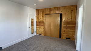 Unfurnished bedroom with a closet and carpet flooring