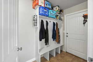Mudroom with light tile patterned flooring and baseboards