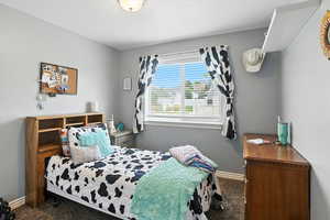 Bedroom with carpet floors and baseboards