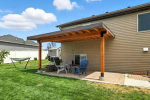 Back of house with a patio area and an outdoor structure