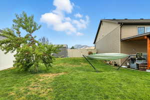 Fenced backyard with a mountain view, a storage shed, and a patio