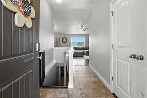 Foyer featuring light tile patterned floors and baseboards