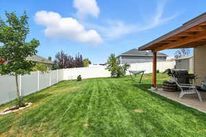 Fenced backyard with a patio area