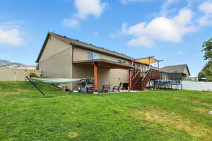 Rear view of house featuring a patio area, a trampoline, a fenced backyard, and stairway