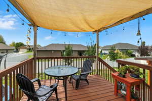 Wooden terrace with outdoor dining area and a residential view