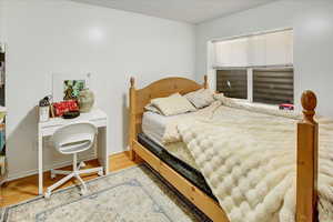 Bedroom featuring wood finished floors and baseboards