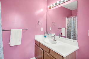 Full bath featuring vanity and a shower with curtain