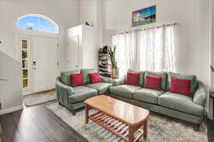 Living room with a high ceiling and wood finished floors