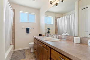 Bathroom with vanity and shower / bath combination with curtain
