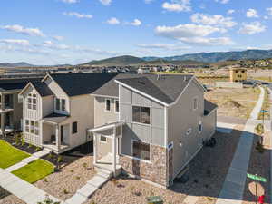 Aerial perspective of suburban area featuring a mountain backdrop