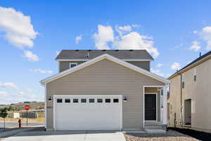 Traditional-style house featuring driveway and a garage