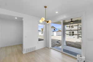 Dining area featuring light wood-style floors, recessed lighting, a chandelier, and a covered patio