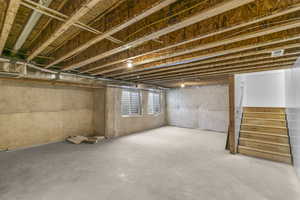 Basement featuring stairs