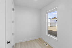 Mud room with baseboards and light wood-style flooring