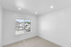 Bedroom 2 featuring light carpet and recessed lighting