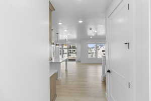 Hallway featuring recessed lighting and light wood-style flooring