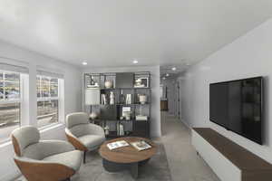 Living area featuring carpet flooring and recessed lighting