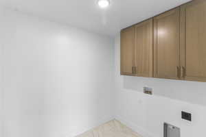 Laundry area featuring hookup for a washing machine, cabinet space, and hookup for an electric dryer