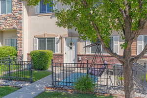 View of front of home with stucco siding and a fenced front yard
