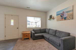 Living room with a textured ceiling and carpet